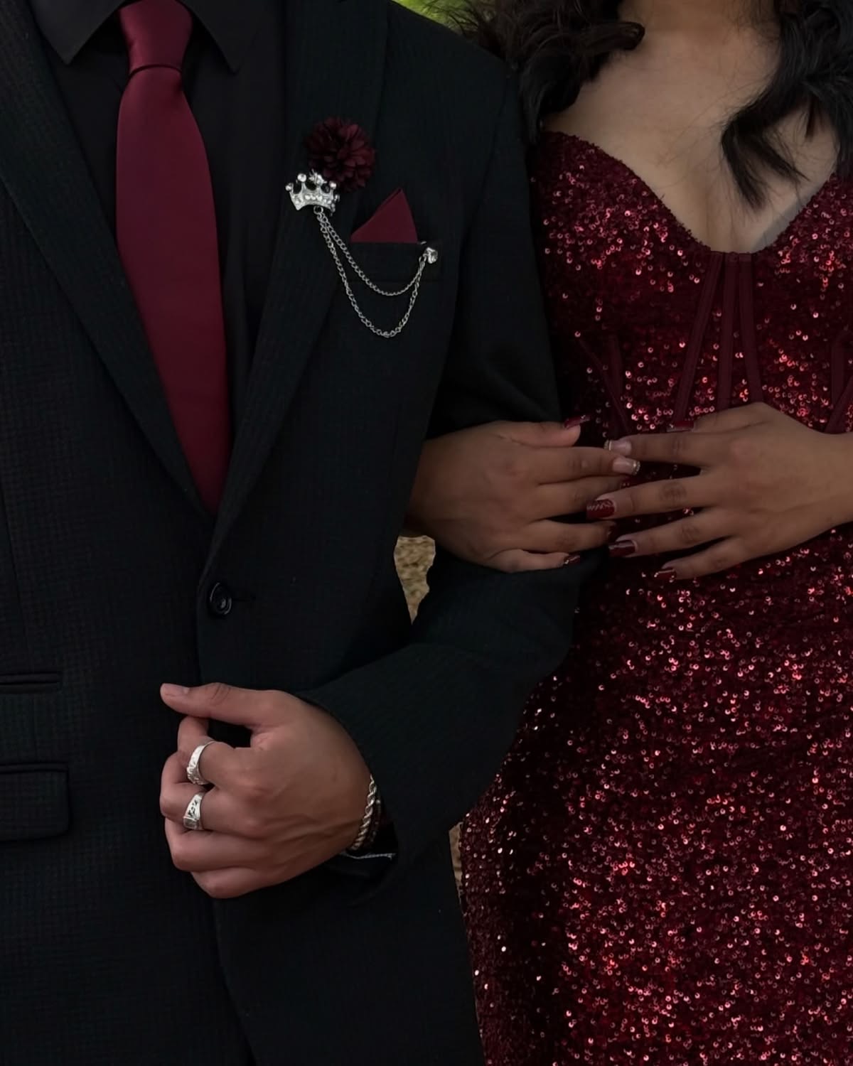 Couple in black suit and burgundy sequin dress